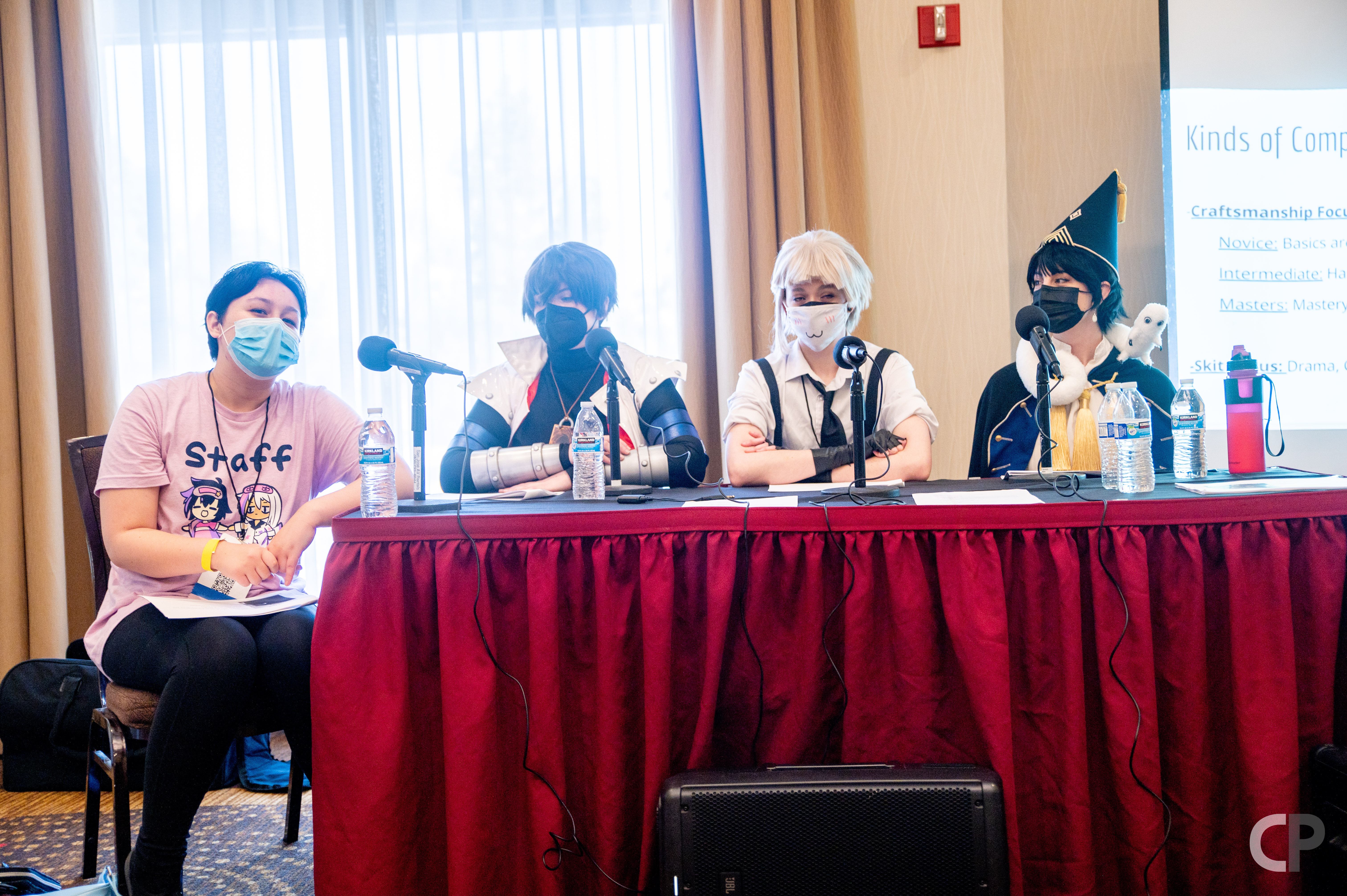 Four people sitting at a table giving a panel at YumeConUSA.